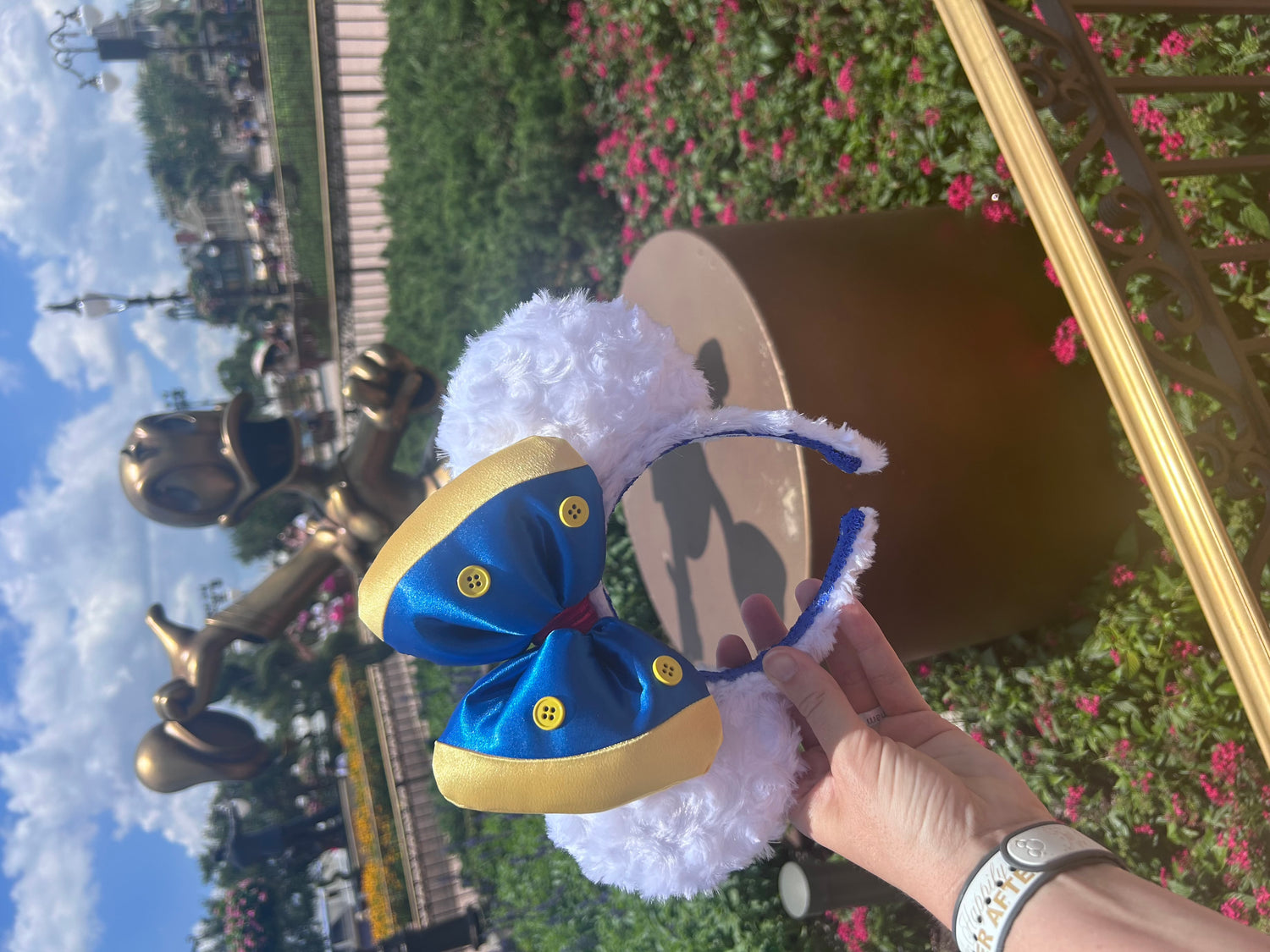 Fluffy white mouse ears with satin blue and yellow bow